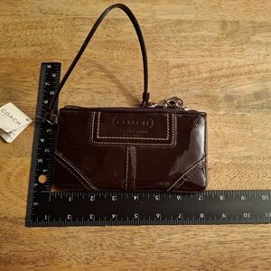 Coach plum patent pochette/wristlet
